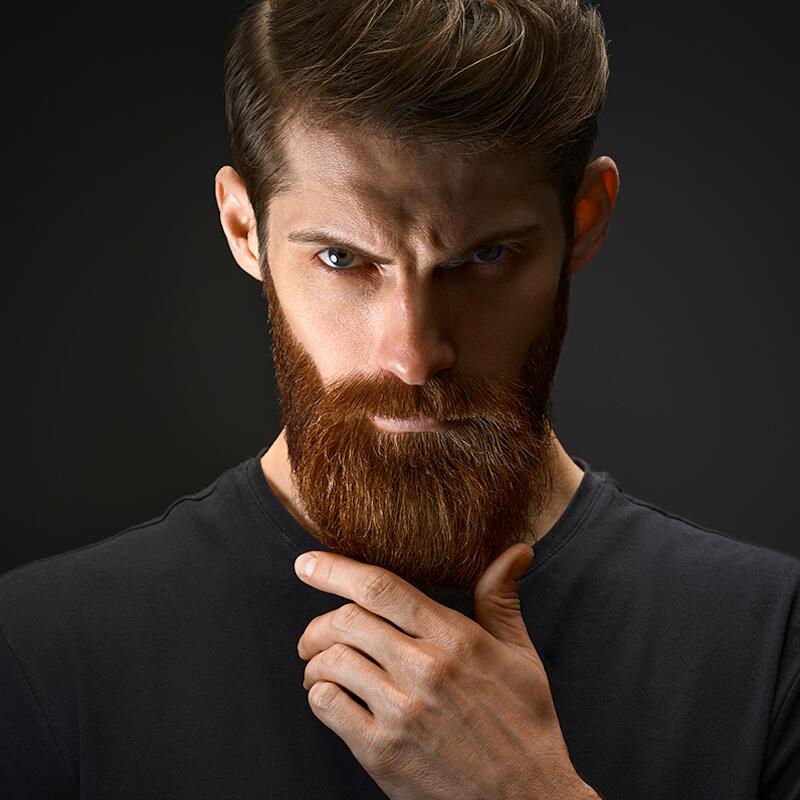 Hansome bearded man looking aside.